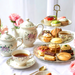 pretty table setting set for tea with petit fours